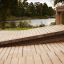 Sit-ups Bench made of wooden planks in an outdoor setting by a lake.