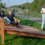 Children playing on a Sit-ups Bench in an outdoor park.