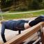Man exercising on Sit-ups Bench outside on a sunny day.