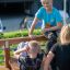 Children using Sit-ups Bench in outdoor gym.