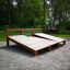 Outdoor Sit-ups Bench made of wood in a park setting.
