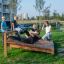 Children exercising on a Sit-ups Bench in a park.