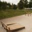 Wooden Sit-ups Bench in an outdoor park.