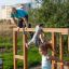 Children playing on Overâ€under playground equipment outdoors.