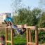 Children playing on the Overâ€under climbing structure in a park.