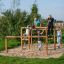 Children playing on the Overâ€under playground structure.