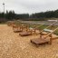 Outdoor fitness equipment Platform 90 in a park setting filled with wood chips.