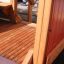 Close-up of Sand Pavilion single playhouse with wooden structures and play area.