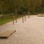 Outdoor fitness equipment set Platform 180 in a natural park setting.