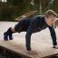 Man performing a push-up on the Platform 180 outdoor exercise equipment.