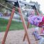 Children playing on Swing Frame 1(BNS) +1 (double swing) in a playground.