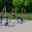 Children playing on Swing Frame 1(BNS) +1 (double swing) at a playground