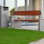 Chicago bin and modern outdoor bench on a lawn