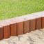 Wooden sand edging boards (running meter) bordering a sandbox and grass area