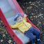 Young child sliding down the Challenger II castle with slide.