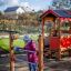 Child playing near Playhouse in a garden.