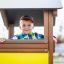 Child playing in a Playhouse at playground.