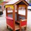 Wooden Playhouse for kids with red and yellow panels.