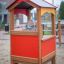 Child playing inside the Playhouse on a playground.