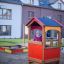 Child playing in Playhouse in playground.
