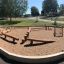 Balancer - wooden playground balance course on a sandy surface.