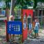Children playing at the Gas Station playground structure.