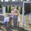 Children playing with Gas Station outdoor playset.