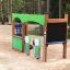 Children's playground equipment 'Gas Station' in a sandy park area.