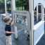 Children playing at Gas Station play structure with memory game panel.