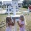 Children playing with bird feeder in outdoor setting