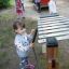 Girl playing on outdoor Xylophone in playground.