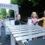 Children playing with outdoor xylophone at playground.