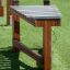 Outdoor wooden xylophone on grass.