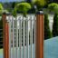Tube Bells playground musical instrument with wooden posts outdoor.