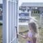 Child playing with Tube Bells outdoor musical instrument.