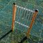 Outdoor musical instrument Tube Bells with green grid flooring.