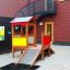 Outdoor Playhouse with slide and climbing wall in modern playground setting