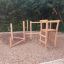 Caucasus wooden playhouse on a gravel playground.