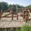 Wooden playhouse Kalahari in a sandy playground.