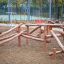 Kalahari wooden playhouse made of natural logs in a playground.