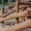 Wooden play structure on sandy playground designed for children by Kalahari wooden playhouse.