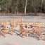 Sonora wooden playground climbing structure with balance beams and rope elements on sand surface