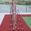 Ural climbing net in a playground setup with wooden supports and red safety flooring.
