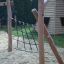 Wooden frame with climbing net in playground, Ural climbing net.