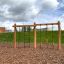 Ural climbing net on a playground with a wooden structure and various climbing challenges.