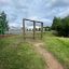 Outdoor wooden climbing frame Irish Table on a grassy field.