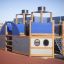 Steamboat ship with slide playground structure with blue and wooden design on rubber safety flooring