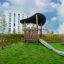 Wooden playground structure with slide and climbing stairs Hekla.
