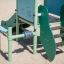 Mars playhouse with slide set on a sandy playground'