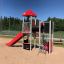 Ladybug playhouse with slide, steel structure on sandy playground